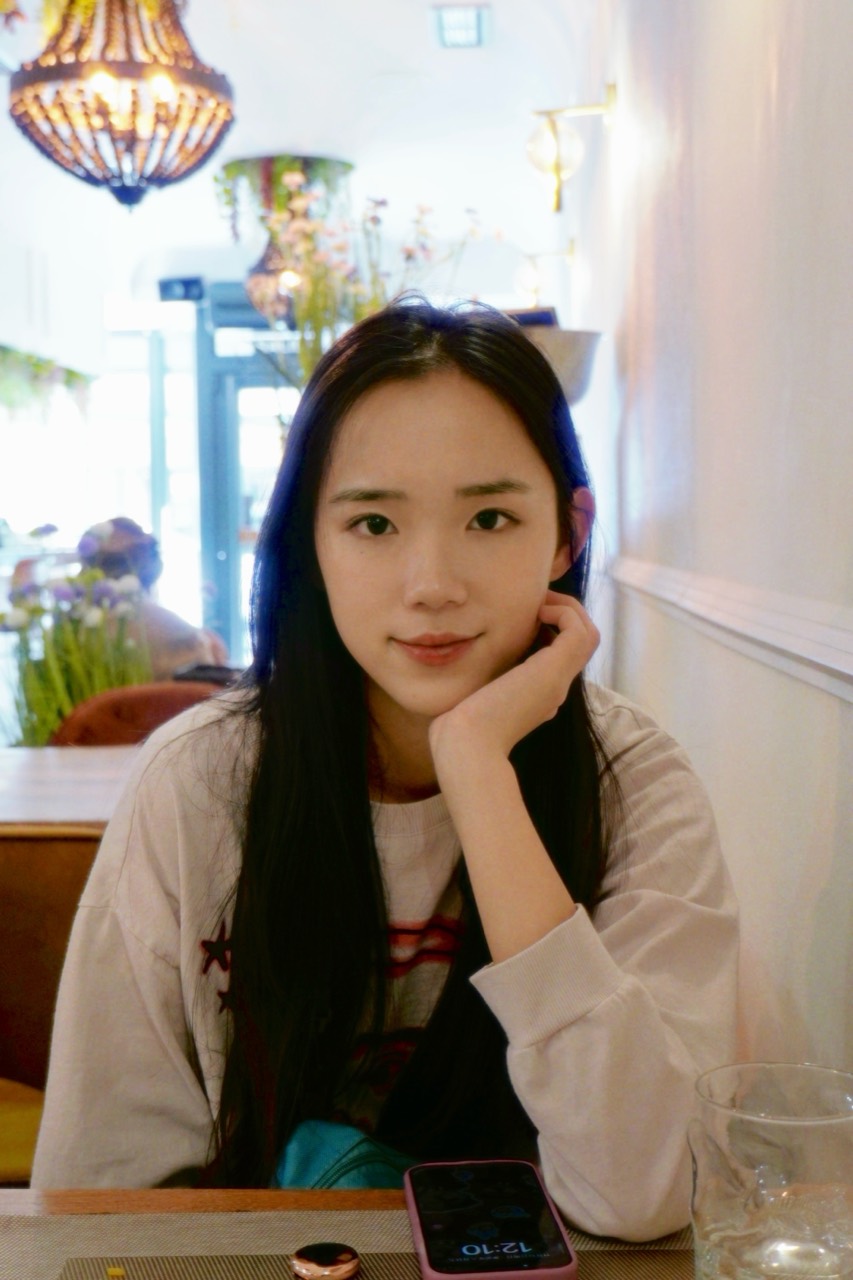 Chenshuo sitting at a cafe table